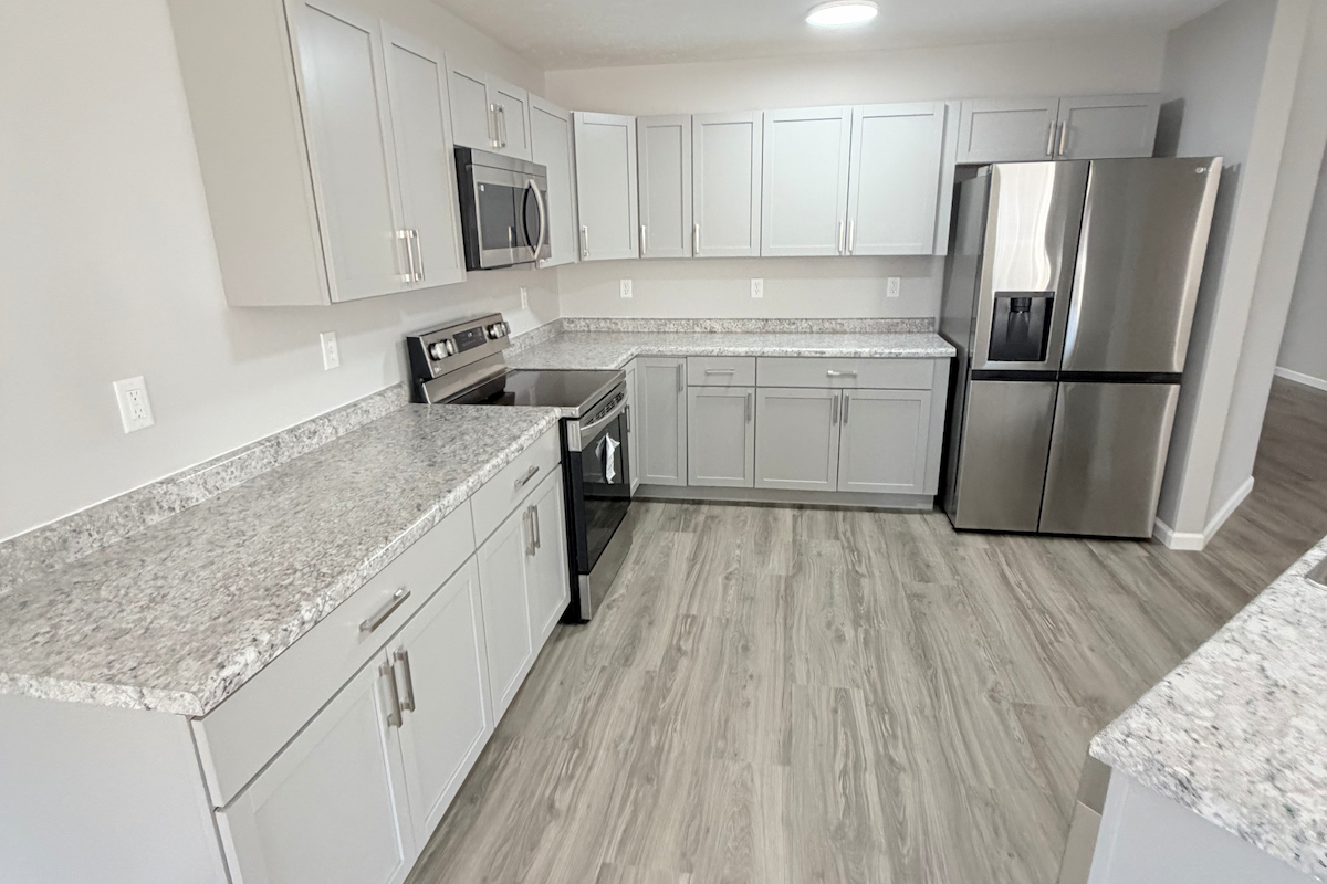 Kitchen remodel with white shaker cabinets and granite countertops